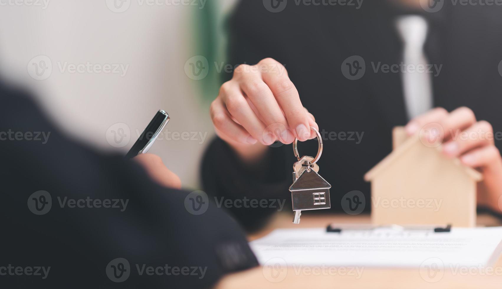 agent broker holding house keychain, handle business documents and agreements, Business contract signing, business cooperation, commercial signing, Signing an agreement ,real estate purchase agreement photo