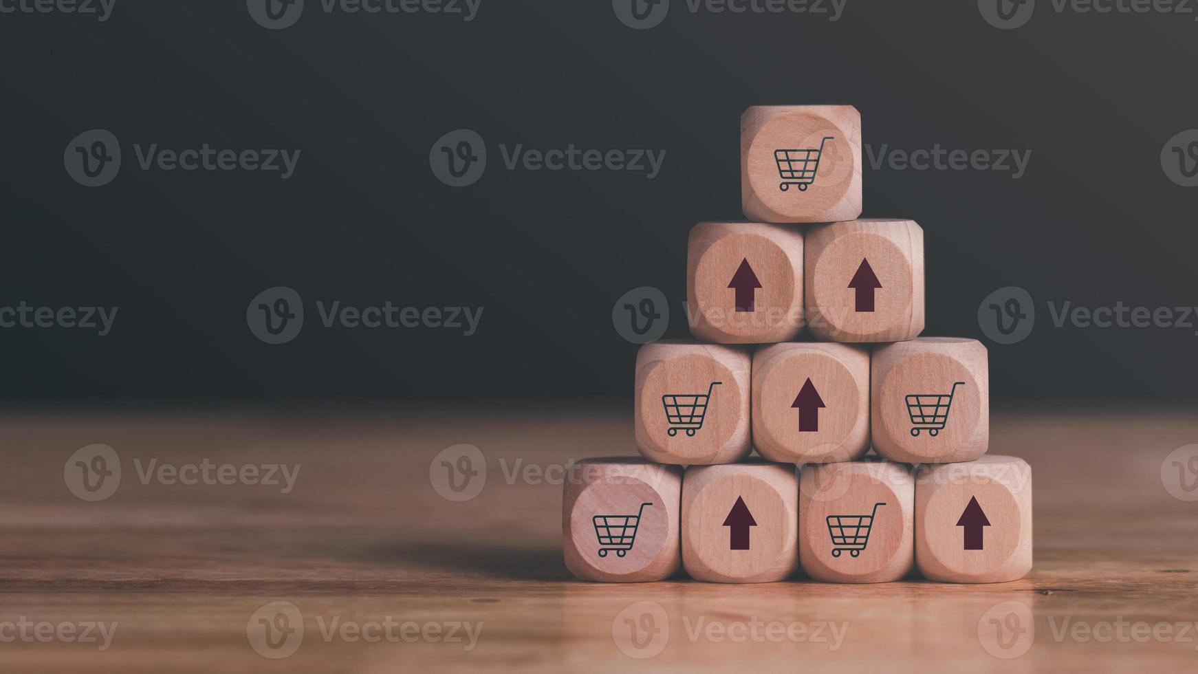 wooden blocks stacked on the table, shopping carts and arrows representing sales or business growth, Online shopping concept, e-commerce, online store ,SME, Startup or small business entrepreneur photo