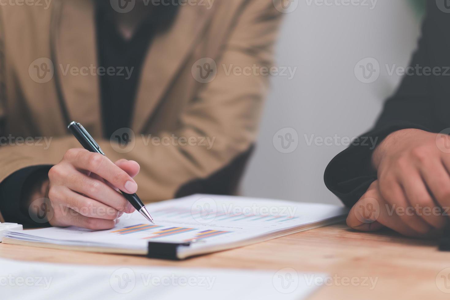business people analyzing chart report and business growth statistics, Analysis and improvement of corporate strategy Manage financial and marketing documents Adjust the annual budget account. photo