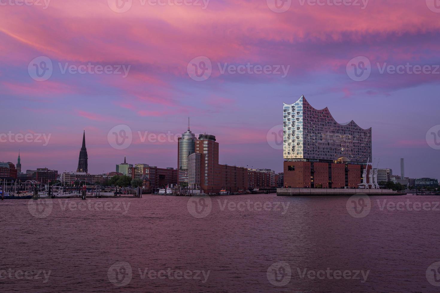 A colorful sunset from Hamburg Waterfront in Northern Germany with the Iconic Elbphilharmonie building in front photo