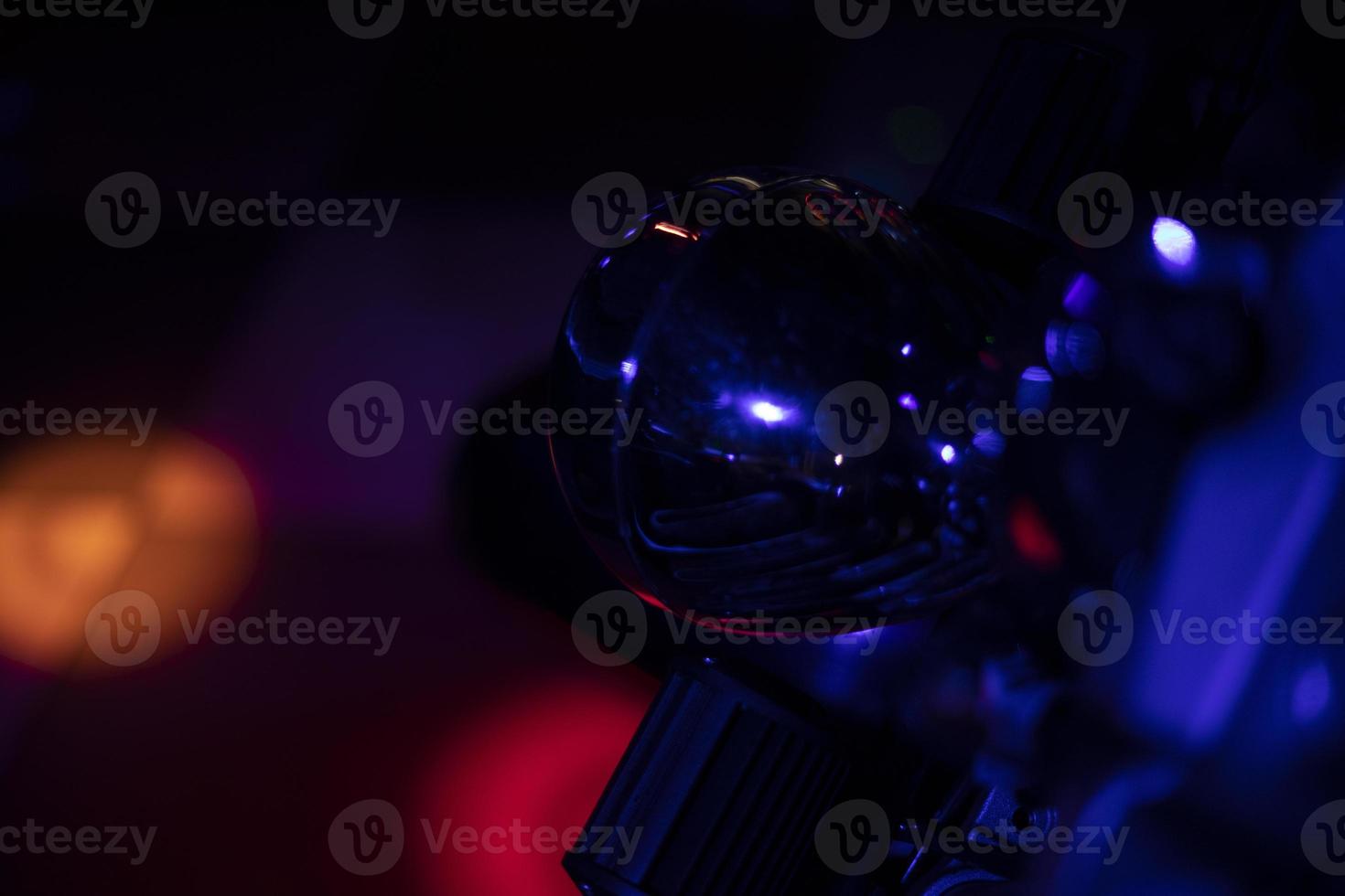 Motorcycle details in colored light. Transport at disco. Light on object. photo