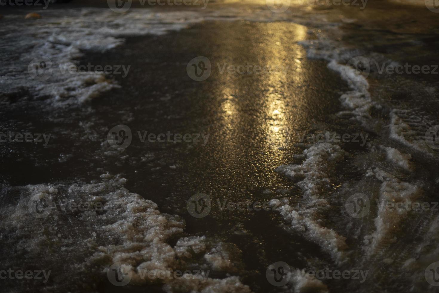 Big puddle at night. Lots of water in parking lot. photo