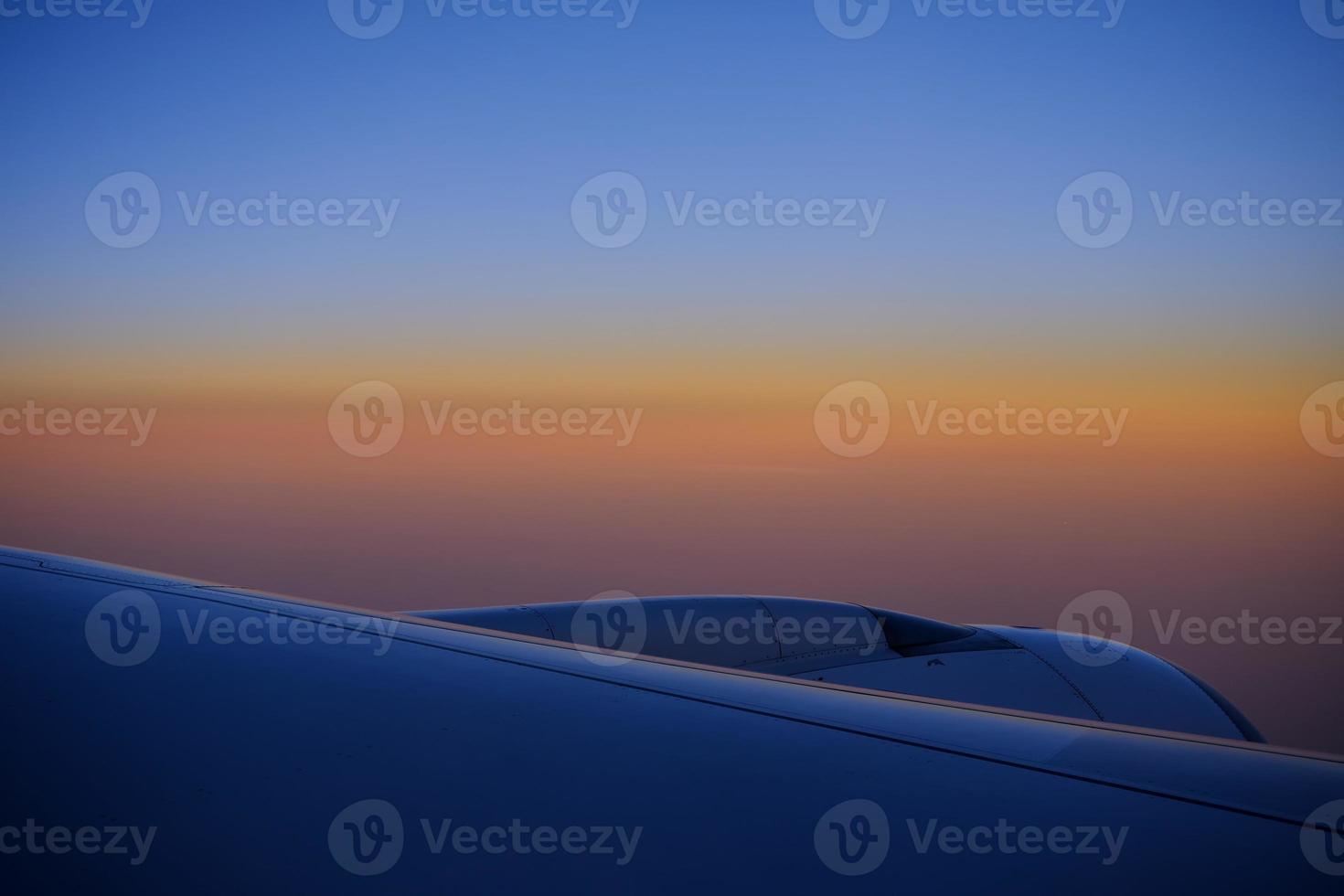 Close up Airplane Wing with Beautiful Skyline Background. photo