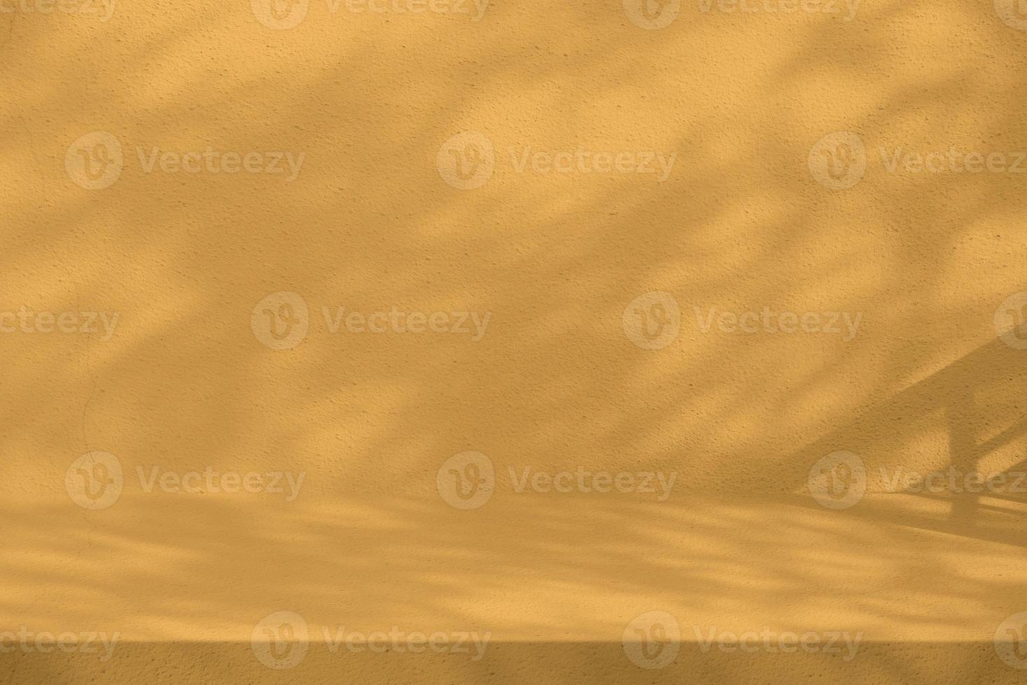 Golden Apricot Concrete Table with Tree Shadow on Wall Texture Background, Suitable for Product Presentation Backdrop, Display, and Mock up. photo