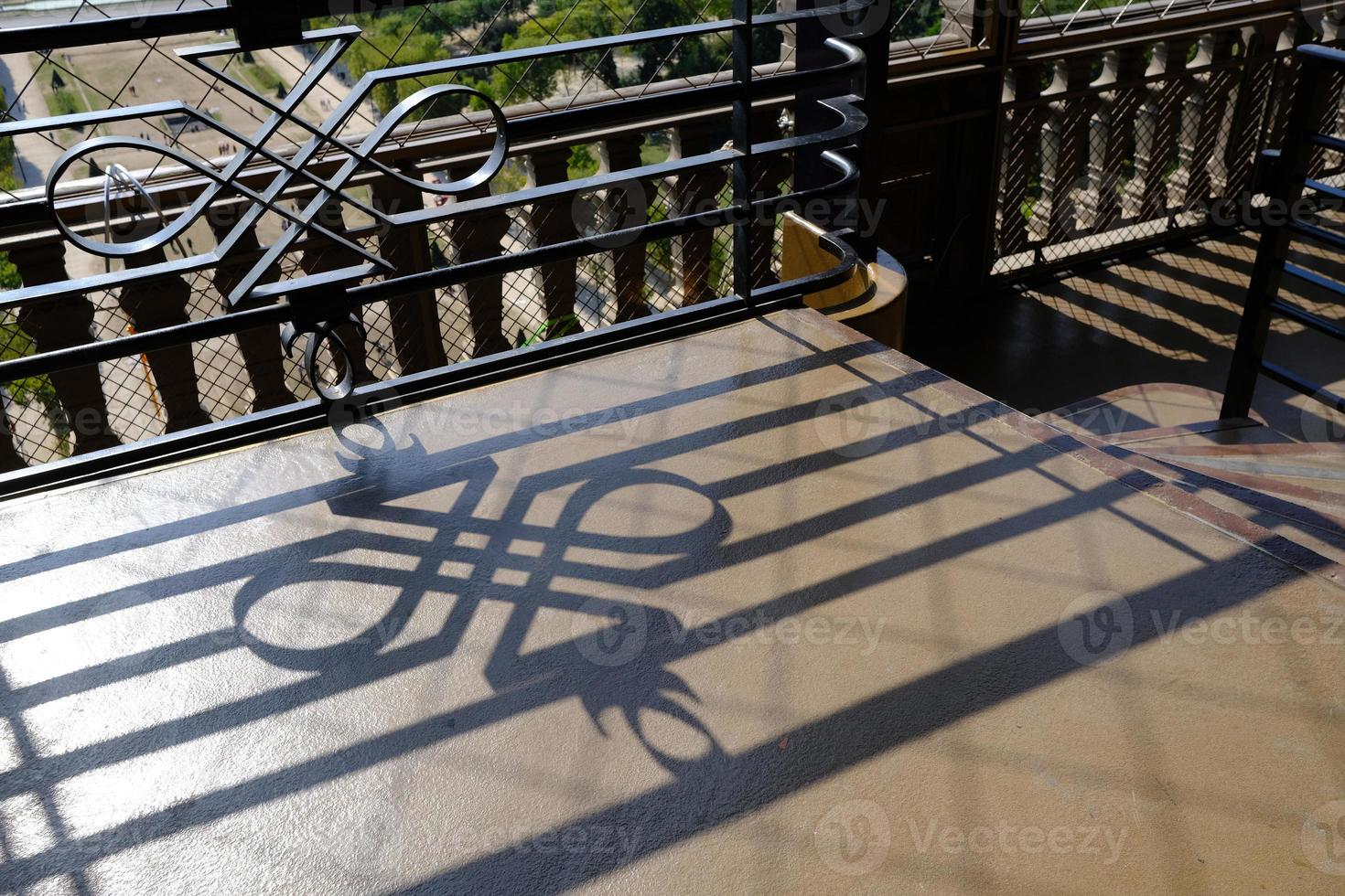 Fence Shadow on the Ground on Eiffel Tower. photo