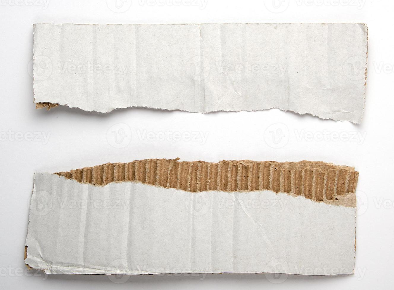 torn piece of paper from under the box in half on a white background photo