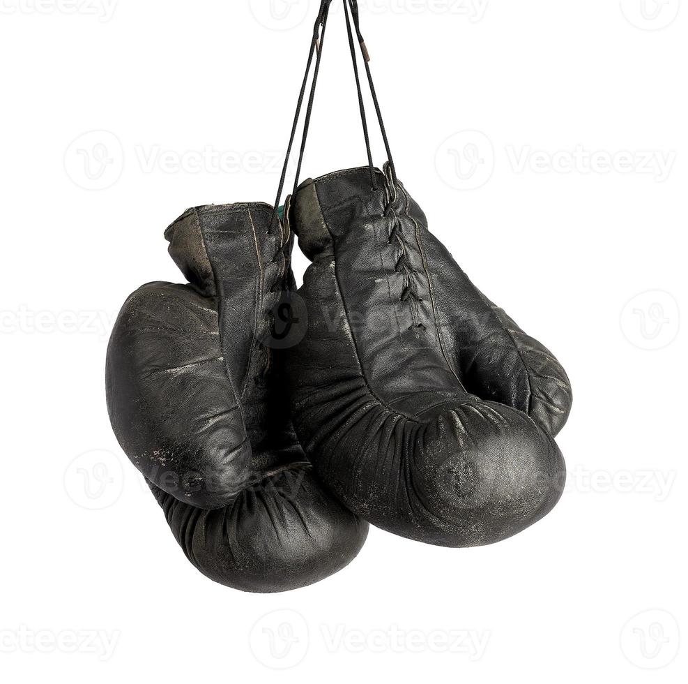 pair of very old vintage black leather boxing gloves hanging on a rope photo