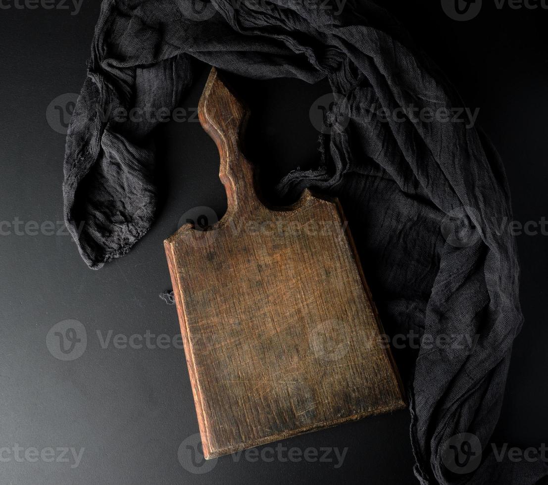 empty vintage wooden brown board and black gauze napkin photo