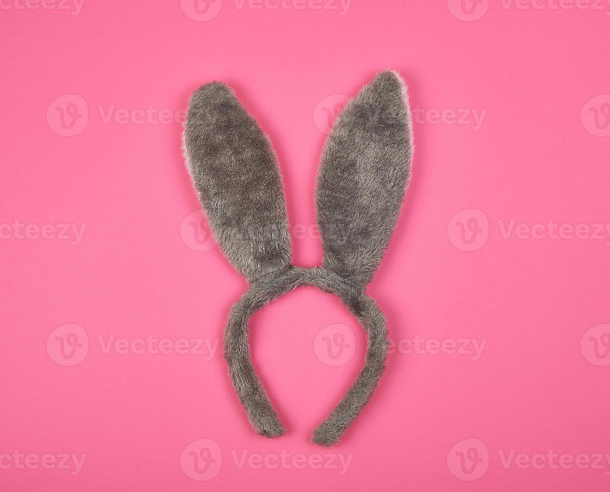 Fur headdress of a hare with ears on a pink background photo