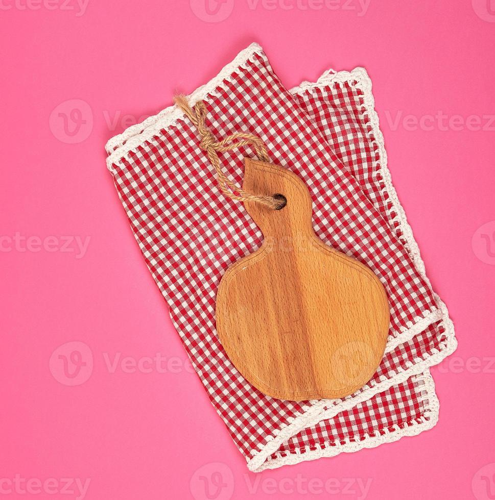 kitchen wooden cutting board and white red checkered kitchen towel photo