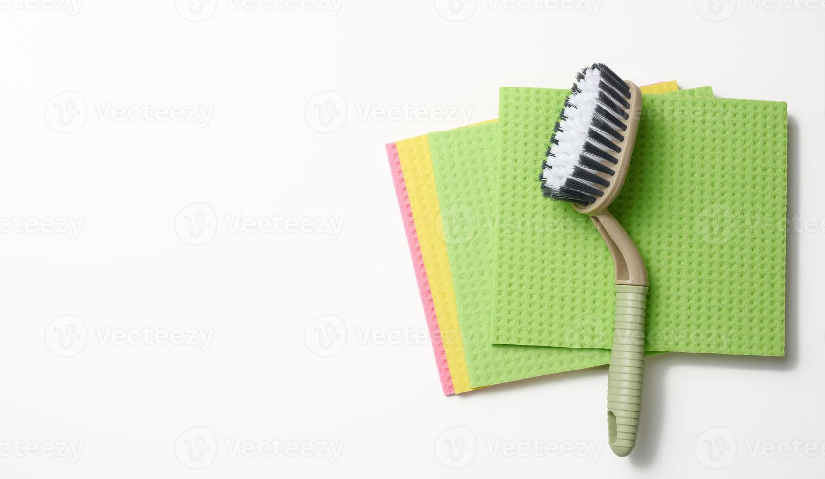 green rug, brush on a white background, flat lay. photo