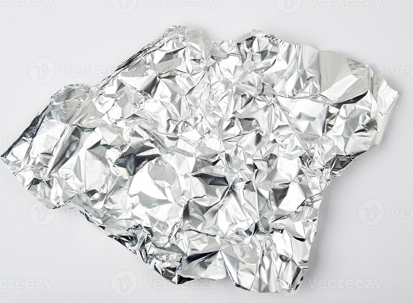 piece of crumpled foil on a white background photo