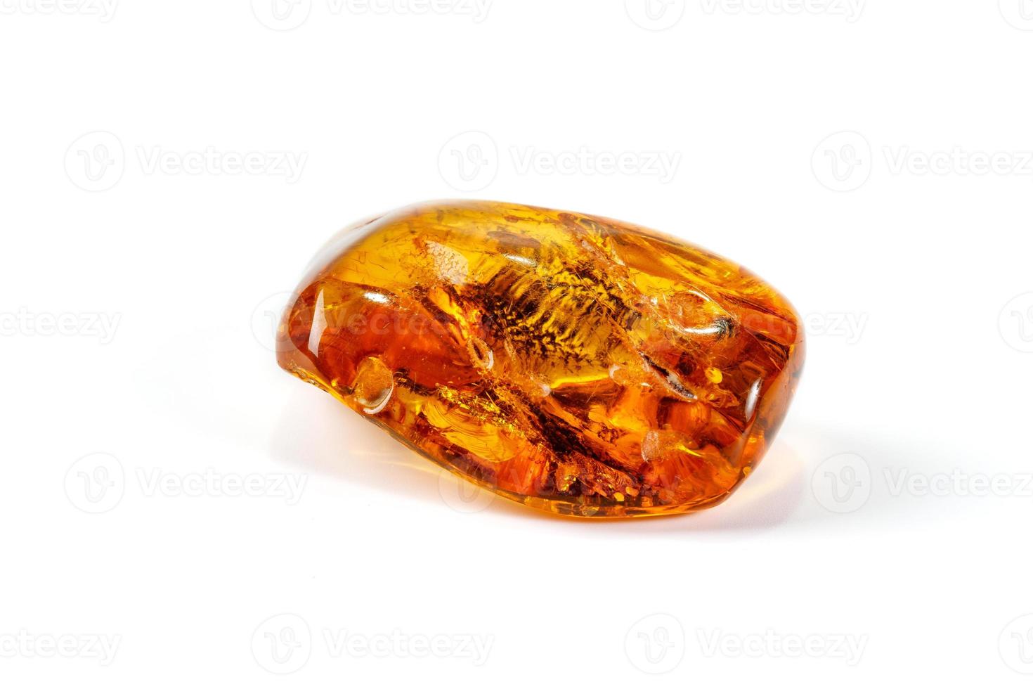 Macro Amber mineral stone with spider on white background photo