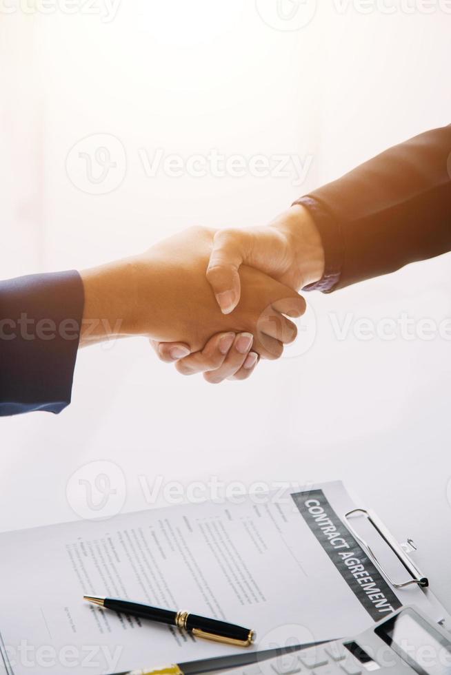 Hand holding car keys and car rental concept A close-up view of the agent, giving the customer the car keys after signing the lease, rental form and car name. photo