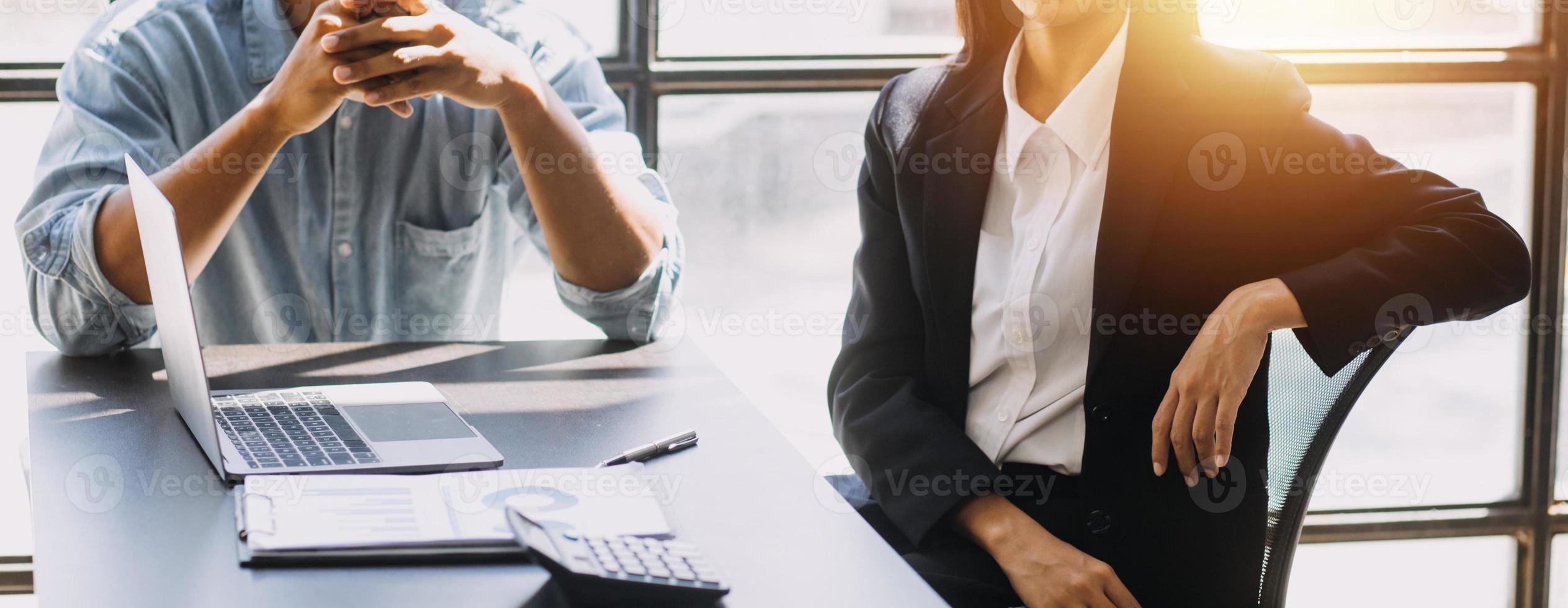 Asian Business woman using calculator and laptop for doing math finance on an office desk, tax, report, accounting, statistics, and analytical research concept photo