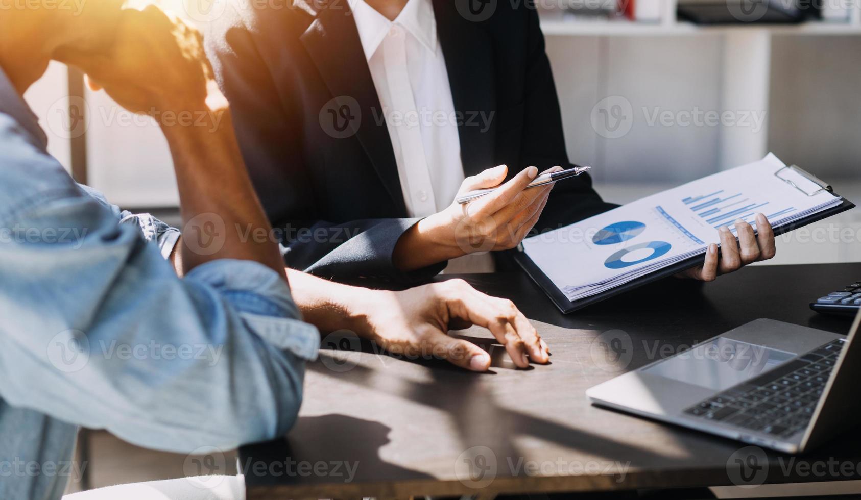 Asian Business woman using calculator and laptop for doing math finance on an office desk, tax, report, accounting, statistics, and analytical research concept photo