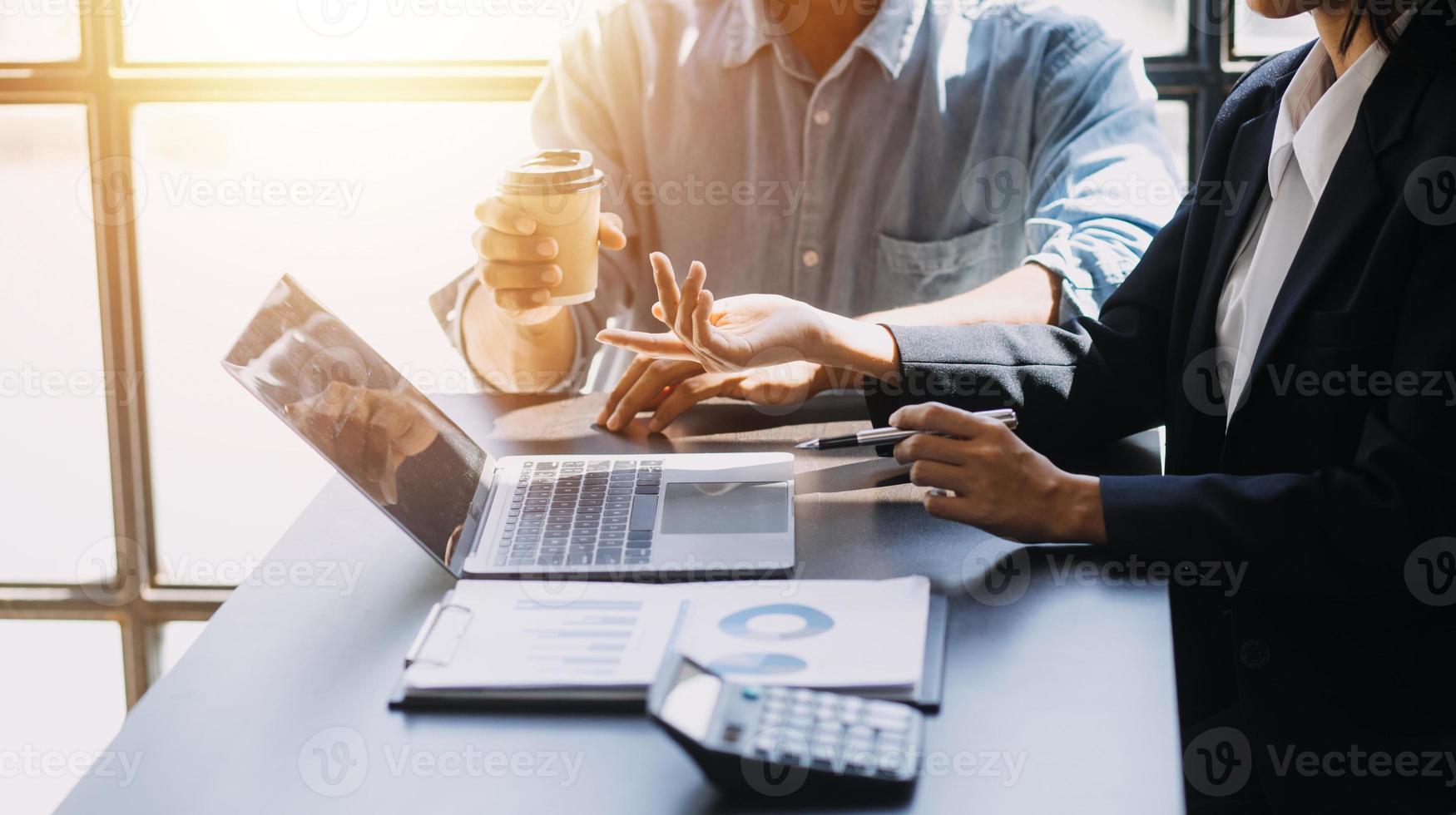 Asian Business woman using calculator and laptop for doing math finance on an office desk, tax, report, accounting, statistics, and analytical research concept photo