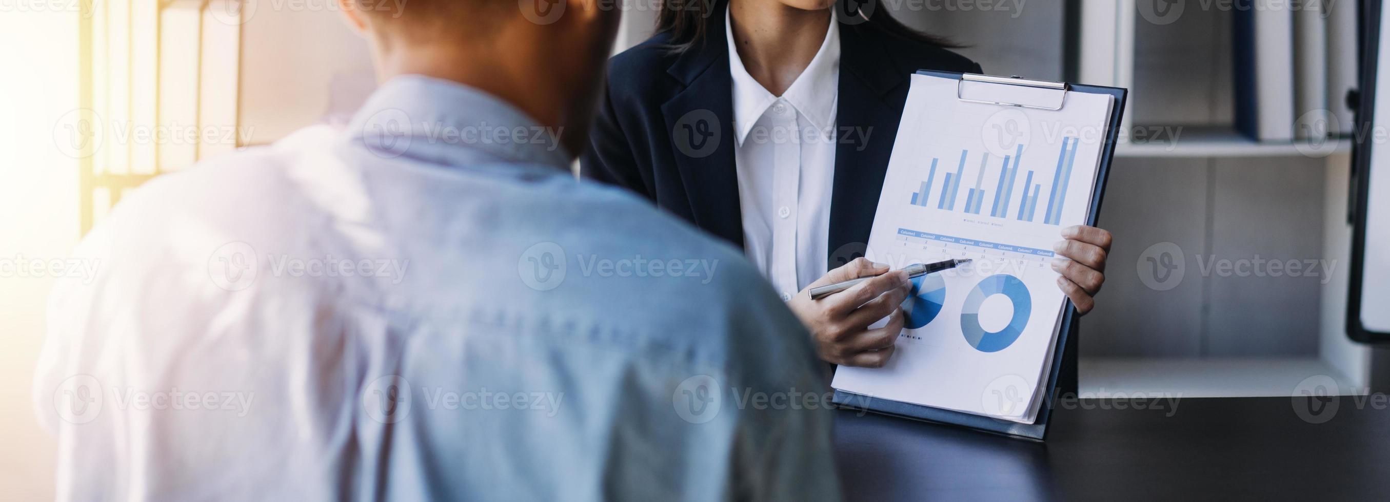 Asian Business woman using calculator and laptop for doing math finance on an office desk, tax, report, accounting, statistics, and analytical research concept photo