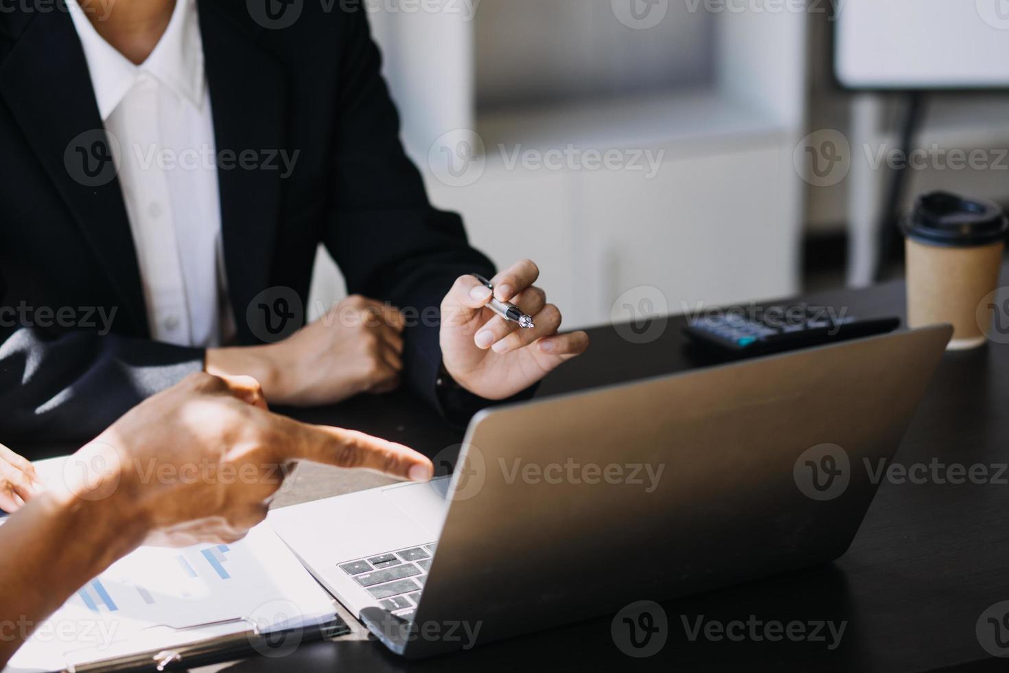 Asian Business woman using calculator and laptop for doing math finance on an office desk, tax, report, accounting, statistics, and analytical research concept photo