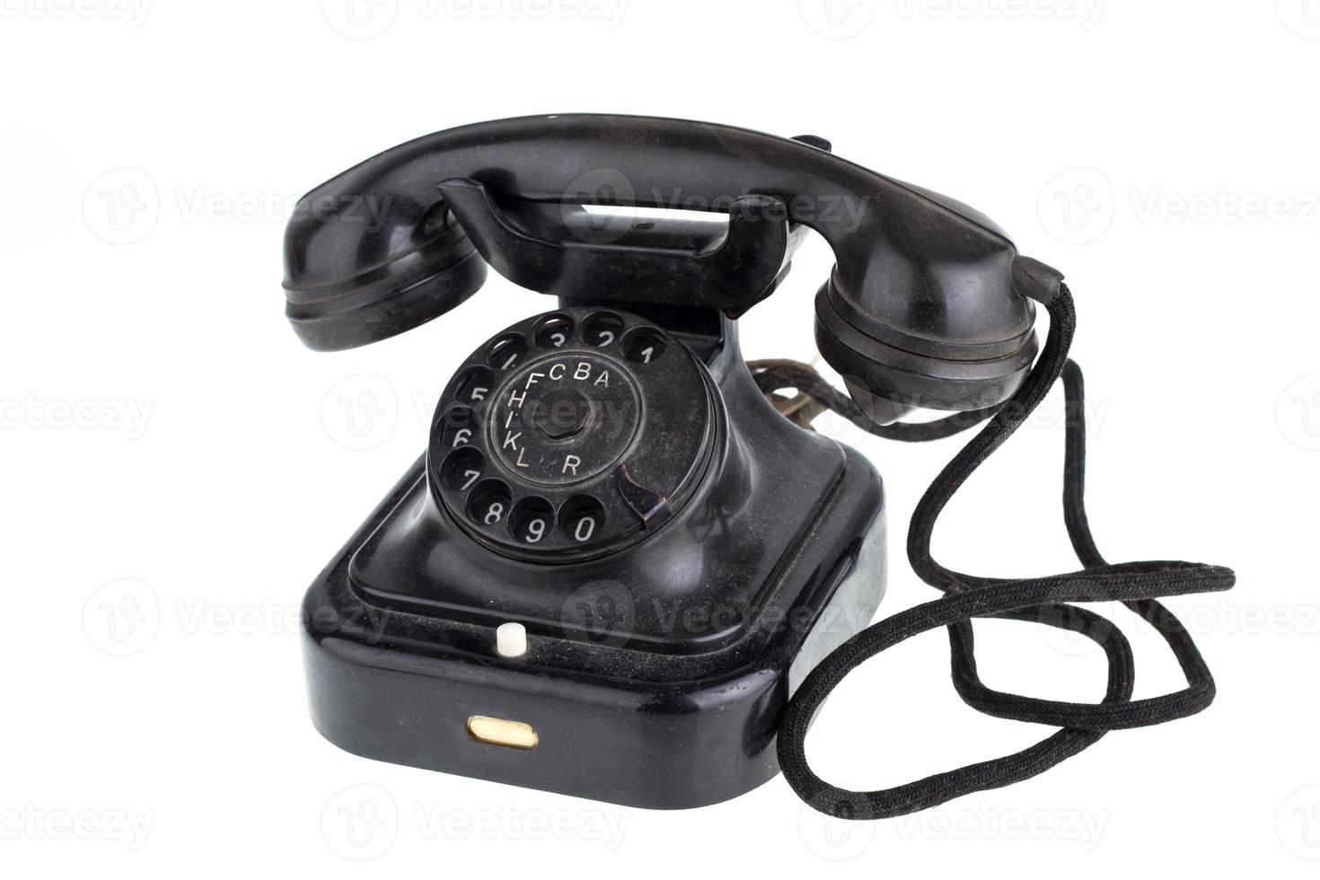 Old vintage black phone on white background photo