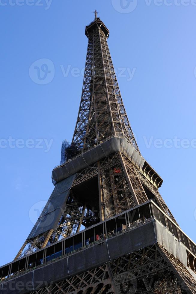 Eiffel Tower Under Construction with Blue Sky Background. photo