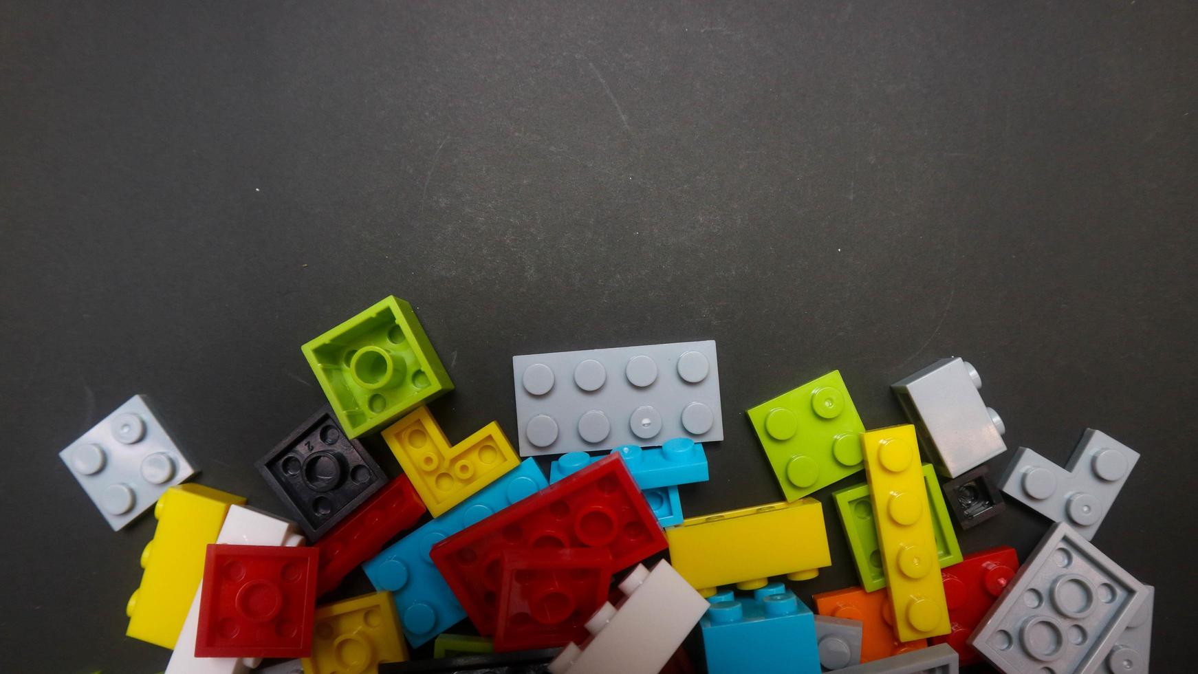 Plastic toy block on a black background photo