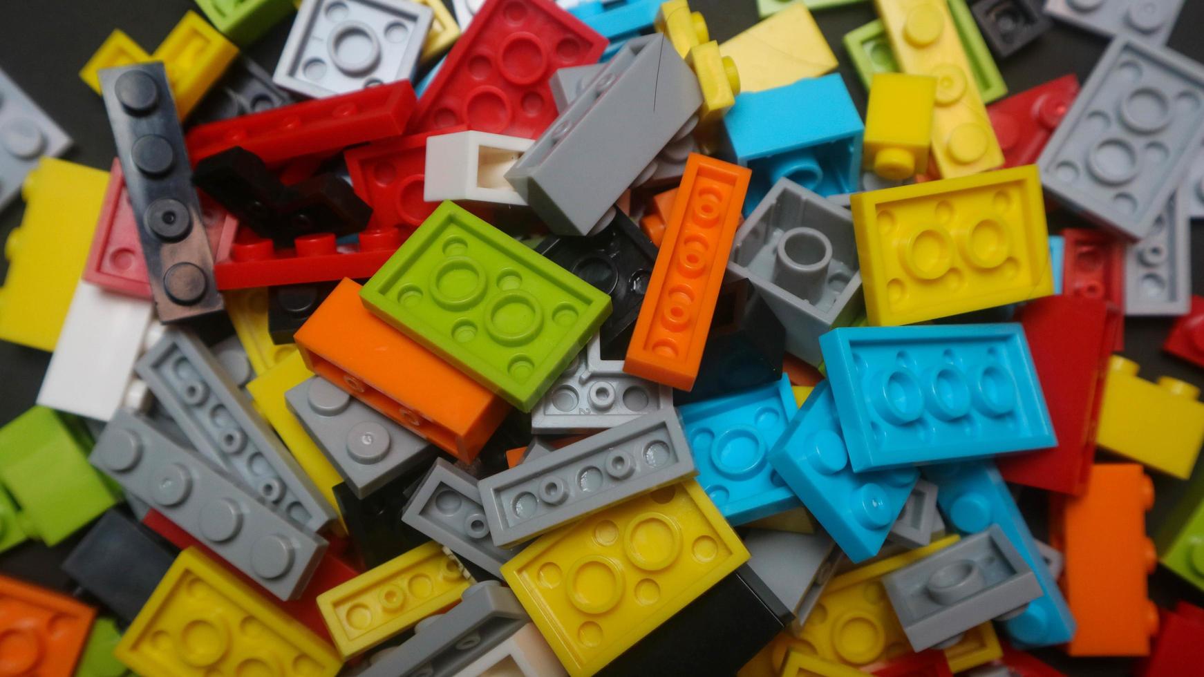 Plastic toy block on a black background photo