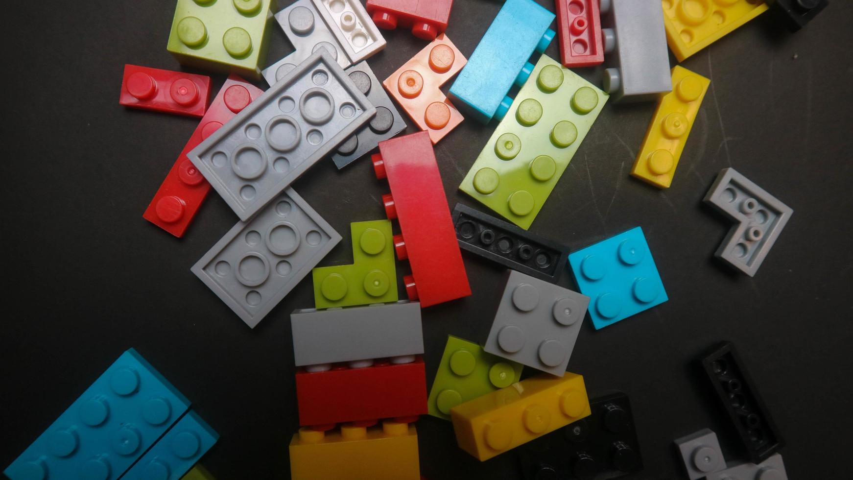 Plastic toy block on a black background photo