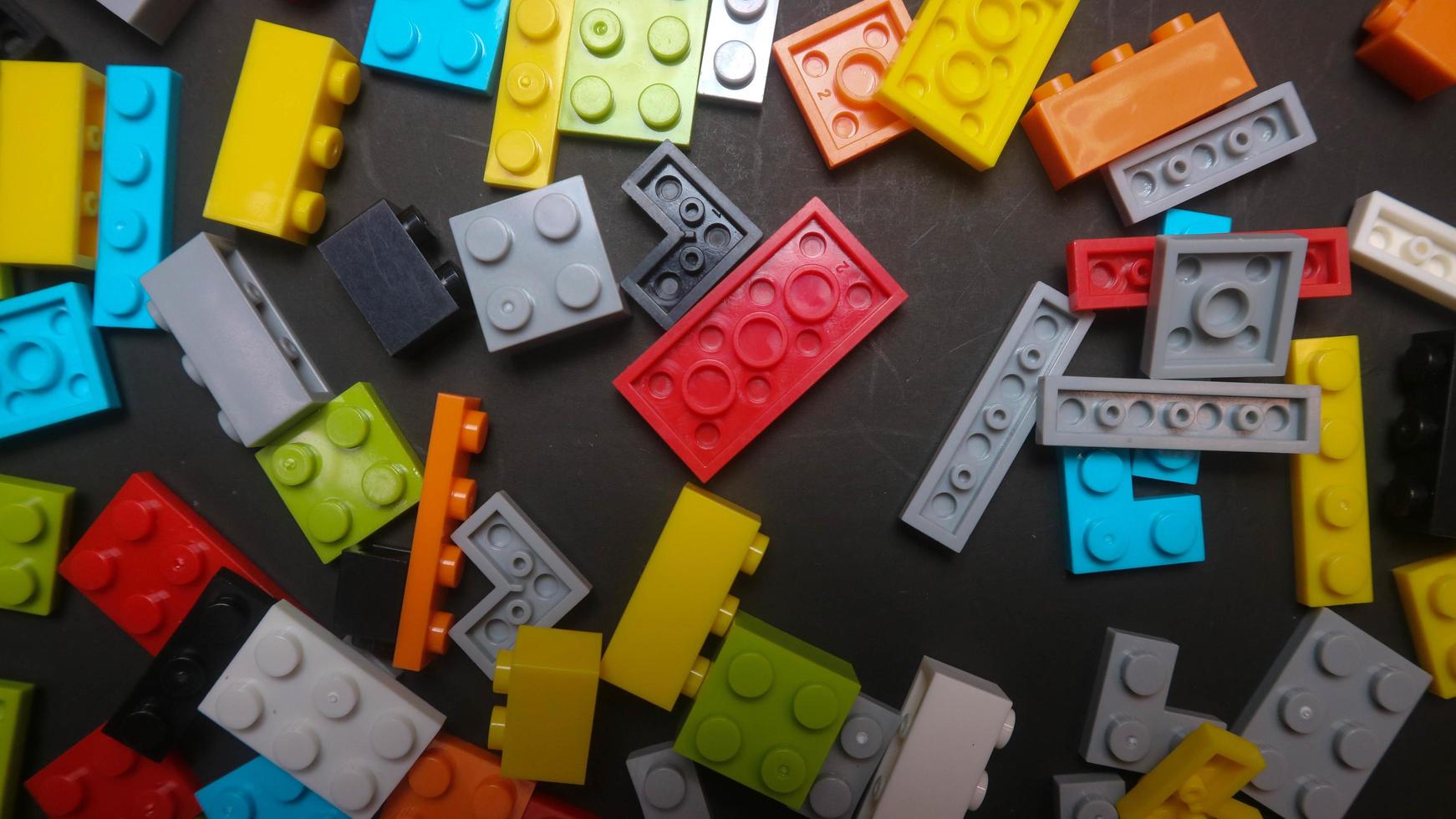 Plastic toy block on a black background photo