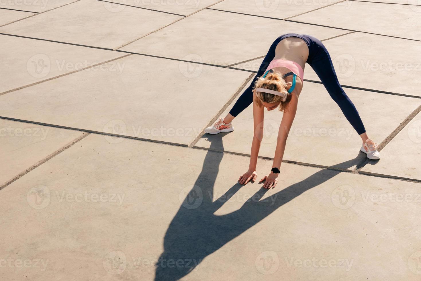 elegant sports girl with headphones working out photo