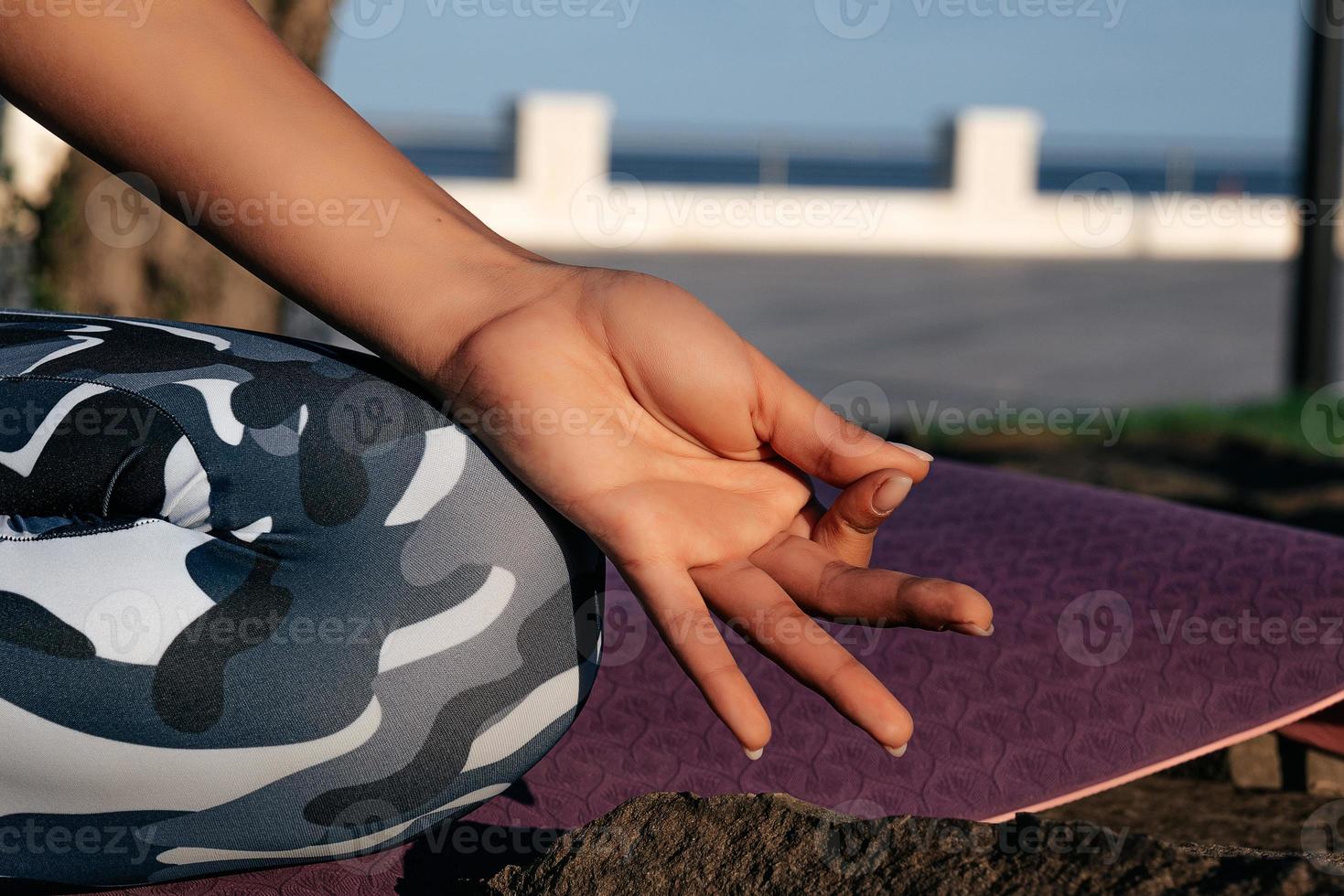 Girl meditates in nature hands close up photo