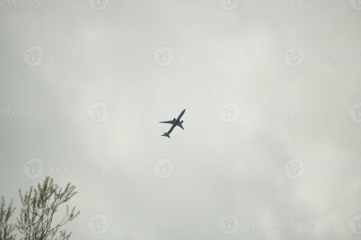 Flight details. Small plane in gray sky. photo