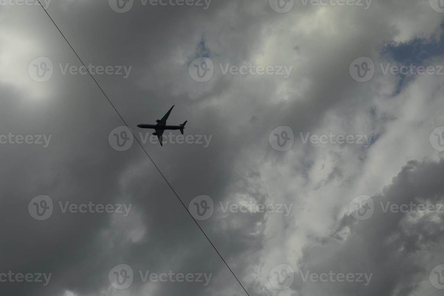 Airplane among clouds. Air transport in sky. Flight details. photo