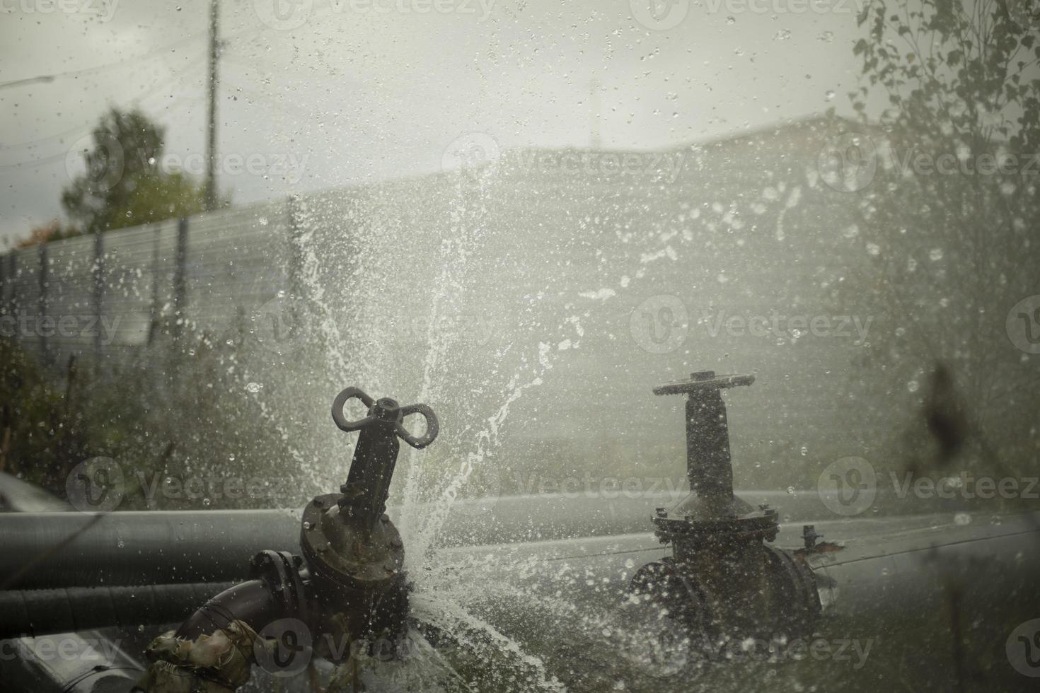 Pipeline burst. Water pours from pipes. Industrial disaster. photo