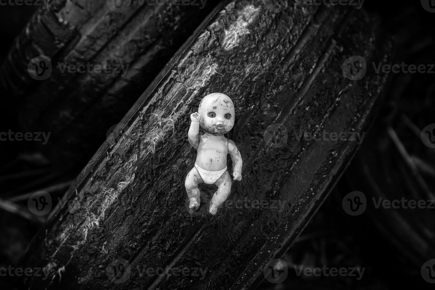 Doll thrown in the trash photo