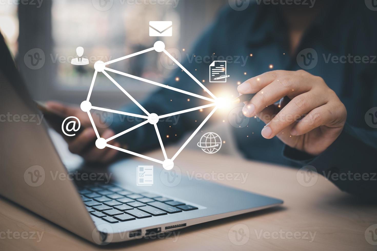 Businessman Hand using a laptop and pen touching on virtual screen contact icons, email and address, Contact us or Customer support hotline people connect live chat with internet wifi, email, phone photo
