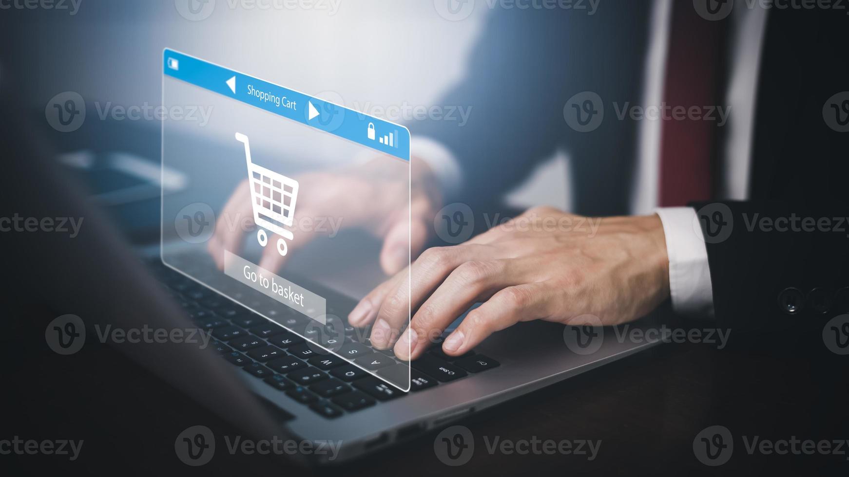 Man using a laptop with typing on a keyboard with online shopping concept, Shopping cart part of the network in hand, Innovation in eCommerce, Online shopping business with selecting shopping cart. photo