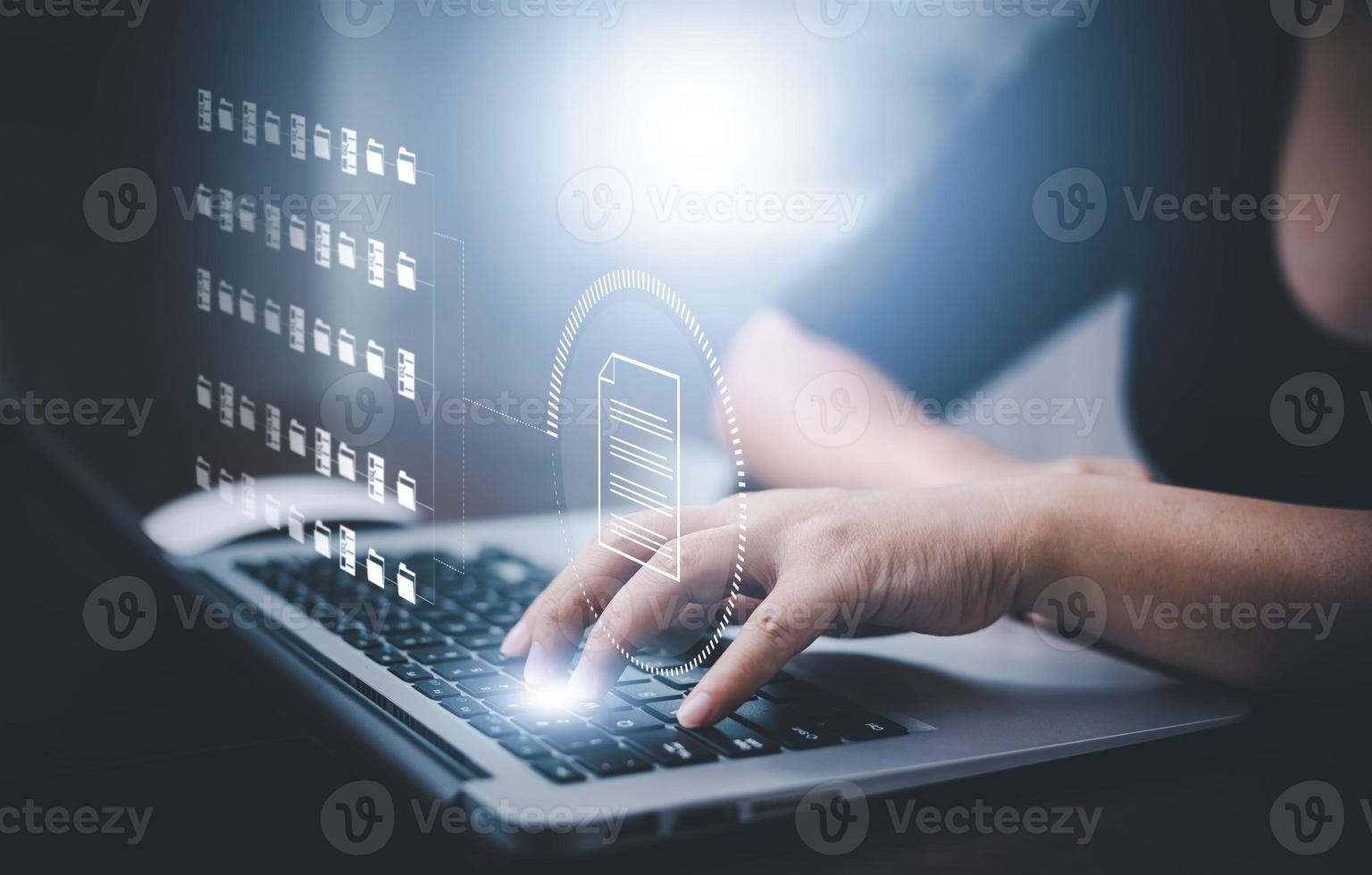 Businesswoman working on laptop with virtual screen. Online documentation database, IT consultant being set up Virtual Document Management System with laptop,Software for archiving corporate files. photo