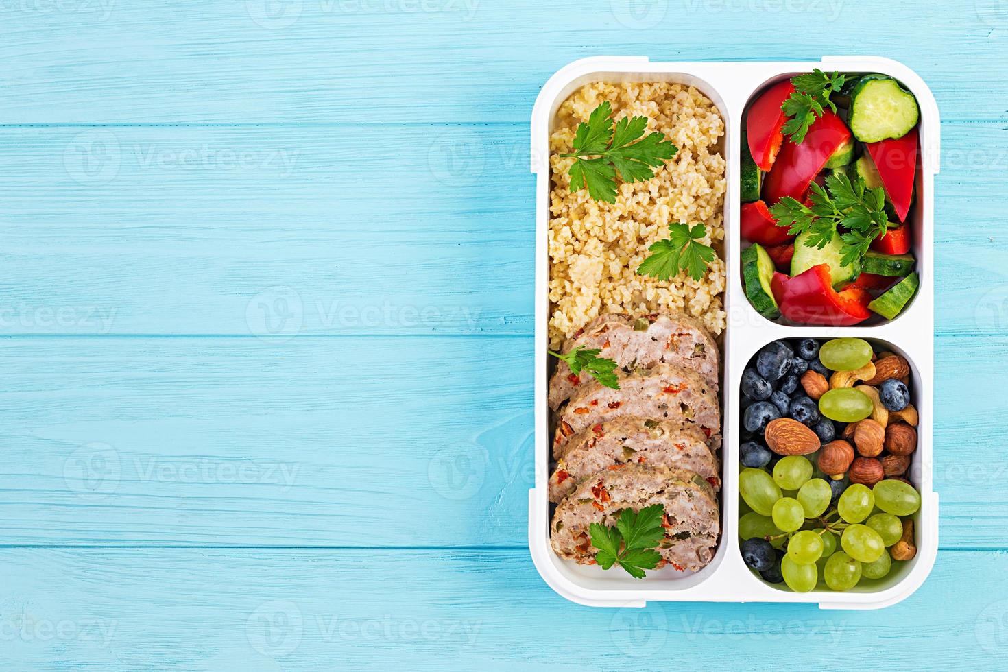 Lunch box  meatloaf, bulgur, nuts, cucumber  and berry. Healthy fitness food. Take away. Lunchbox. Top view photo