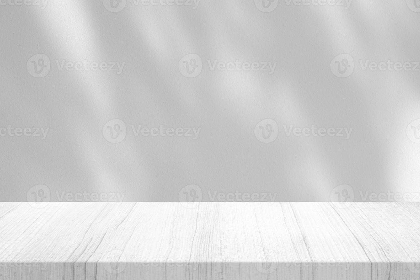 White Wood Table with Tree Branch Shadow on Concrete Wall Texture Background, Suitable for Product Presentation Backdrop, Display, and Mock up. photo