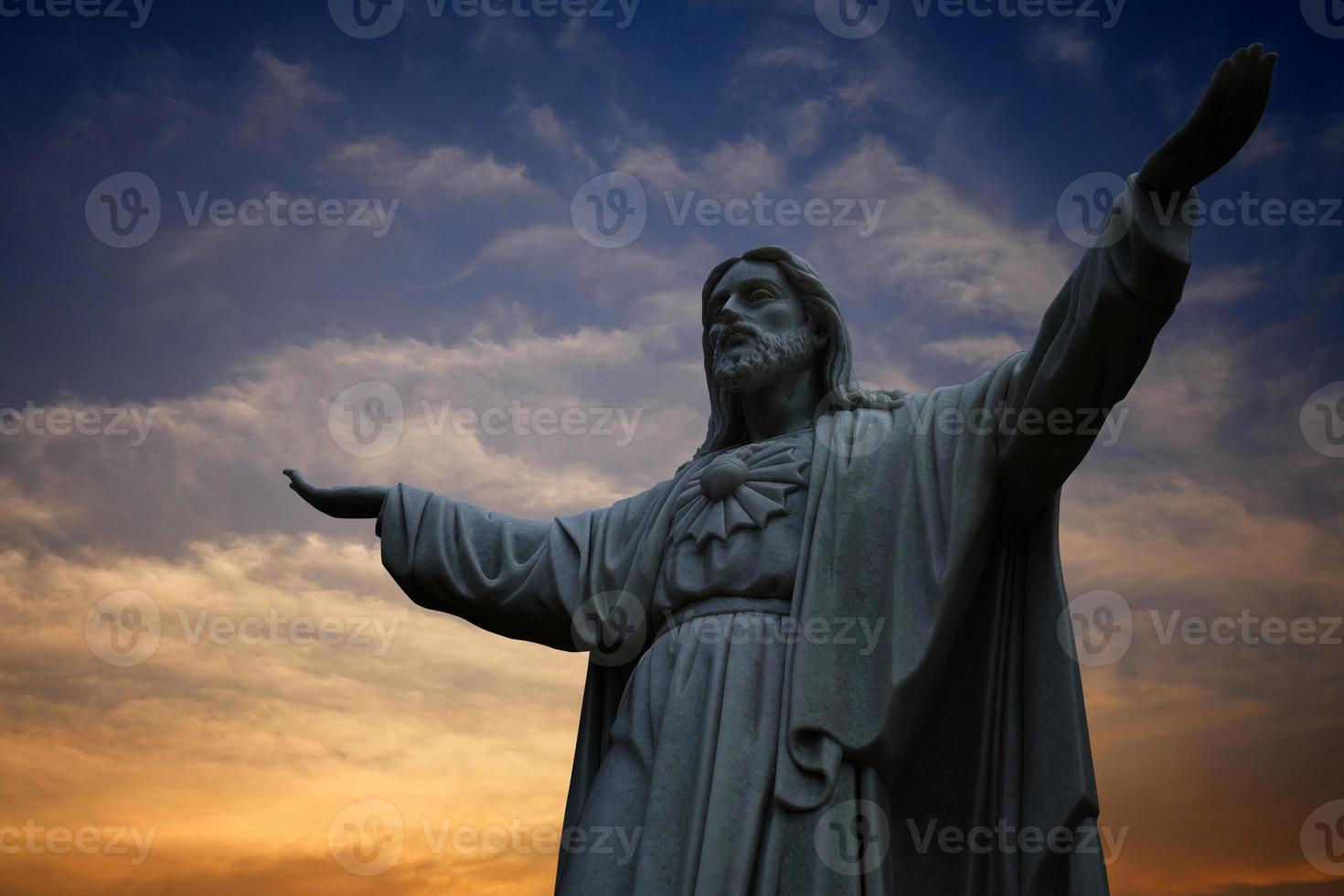 Ancient Jesus Statue with Beautiful Sky Background, Suitable for Religion Concept. photo