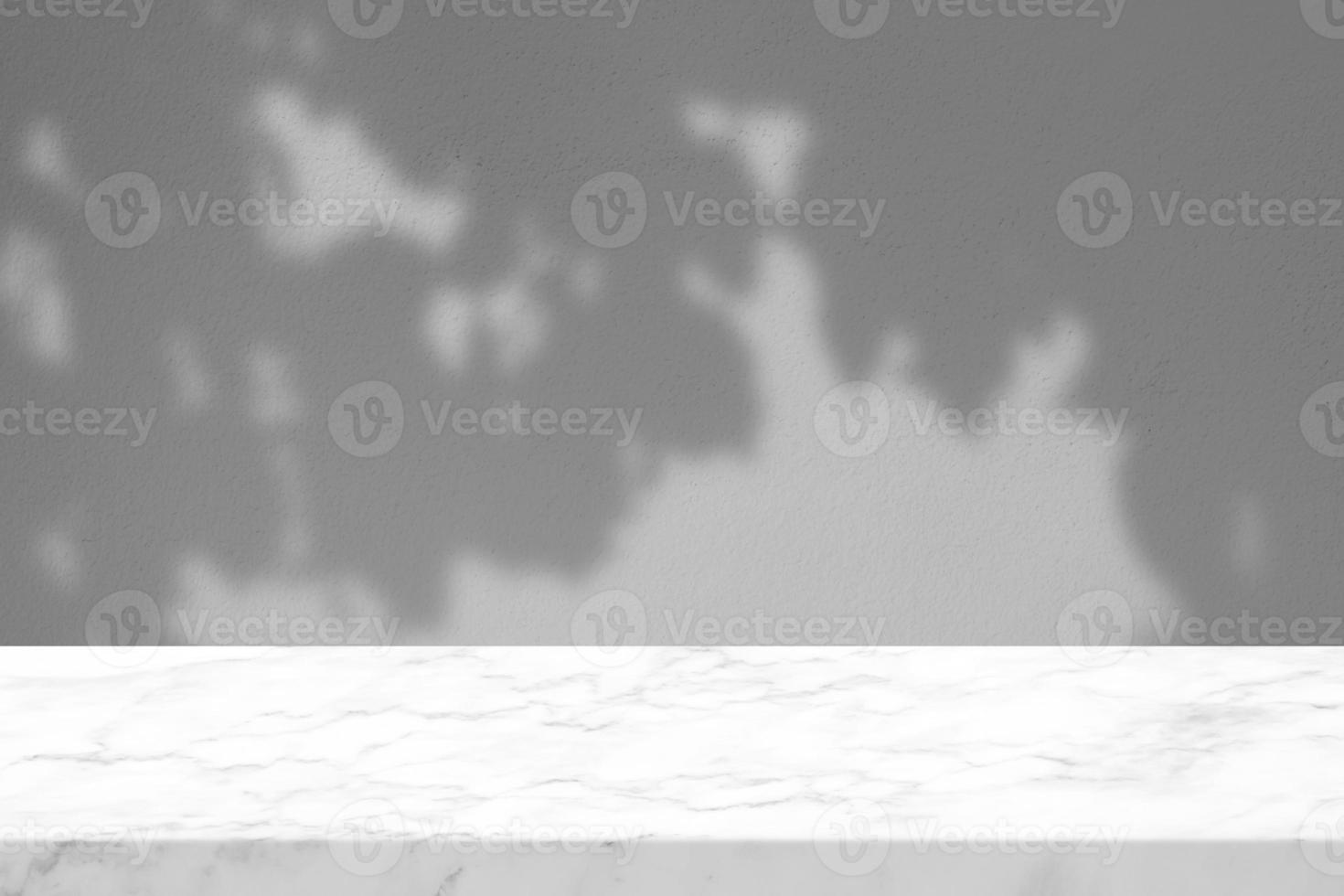 White Marble Table with Tree Branch Shadow on Concrete Wall Texture Background, Suitable for Product Presentation Backdrop, Display, and Mock up. photo