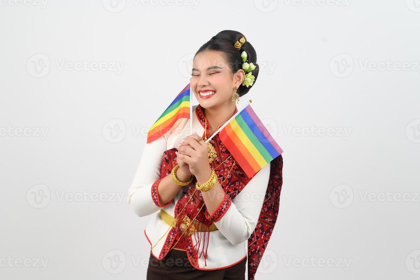 Portrait of Young woman in Thai Northeastern Traditional Clothing holding rainbow flag photo
