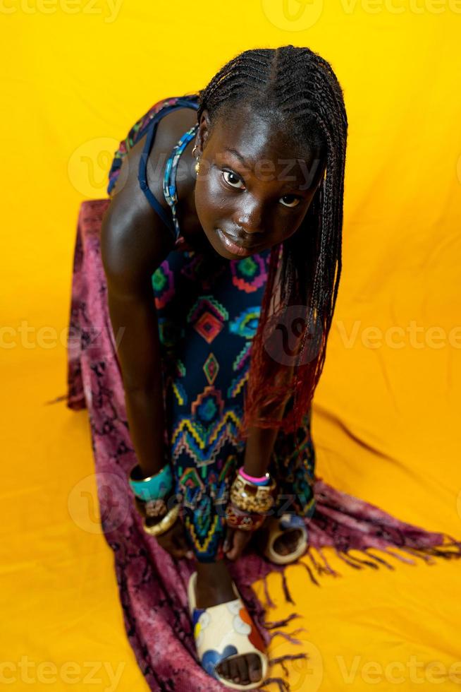 portrait of young cute African teen wearing traditional dress photo