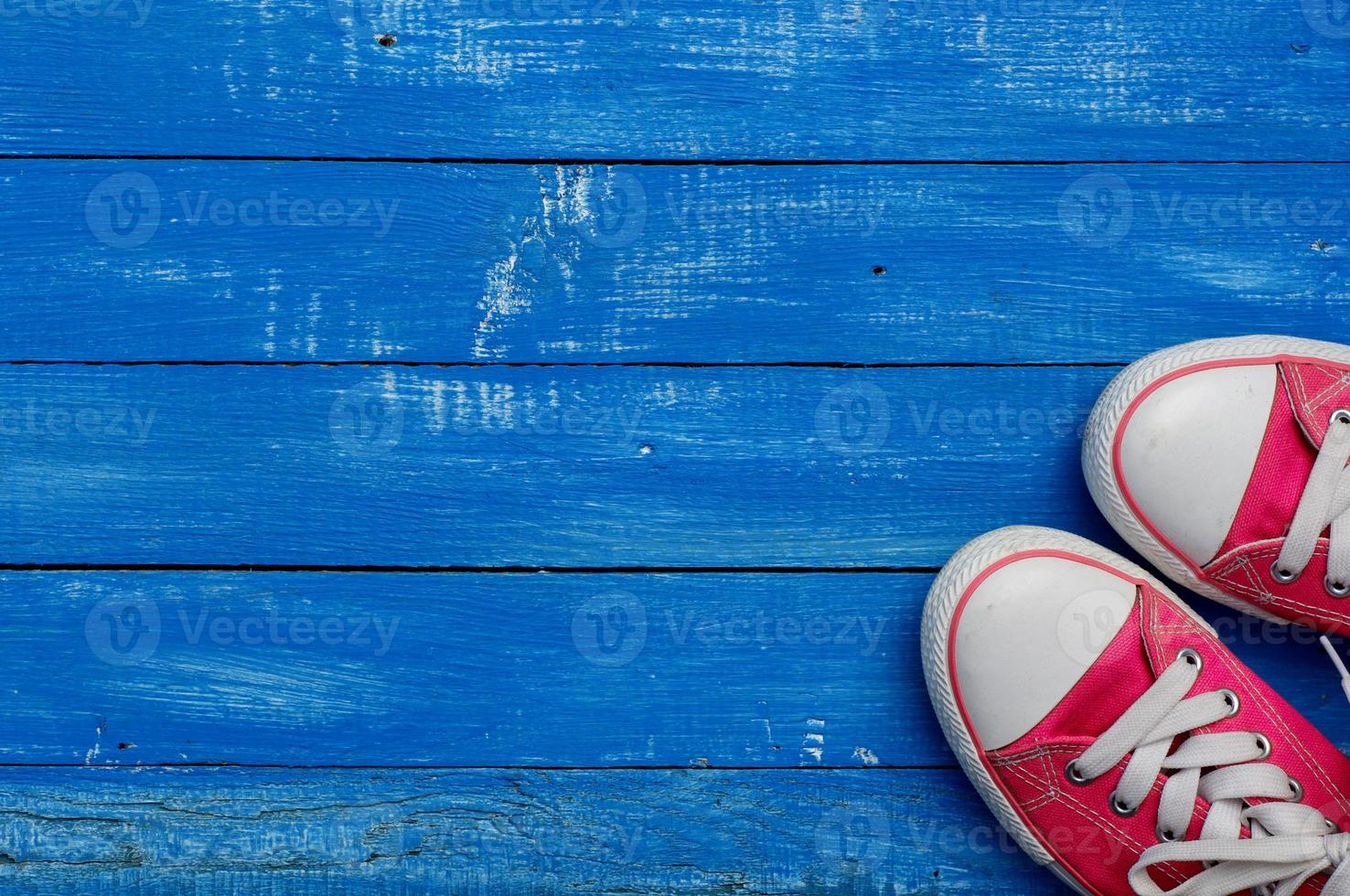 pair of pink sneakers on a wooden floor photo