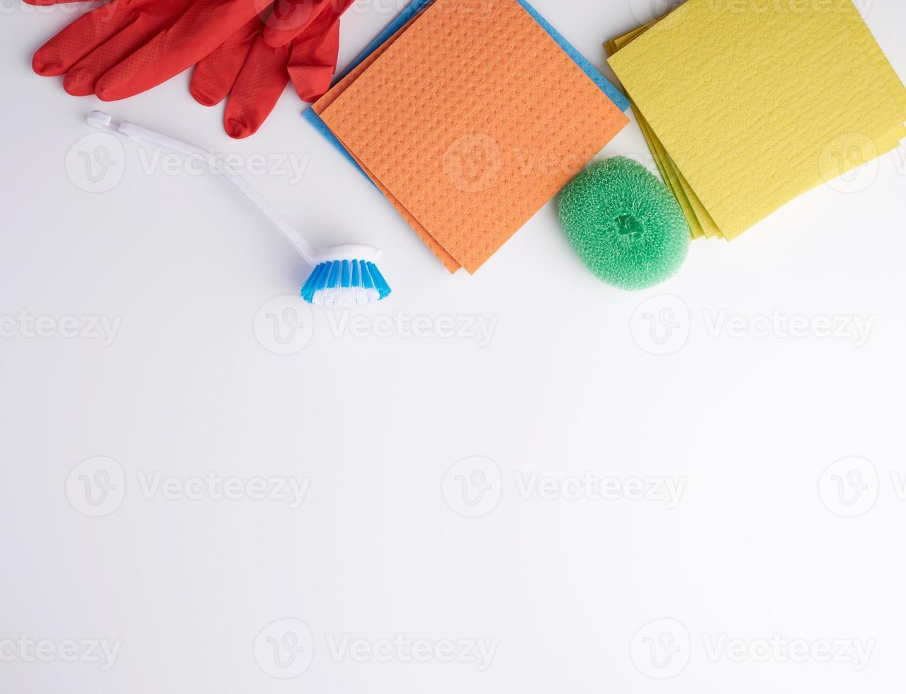 items for home cleaning red rubber gloves, brush, multi-colored sponges for dusting photo