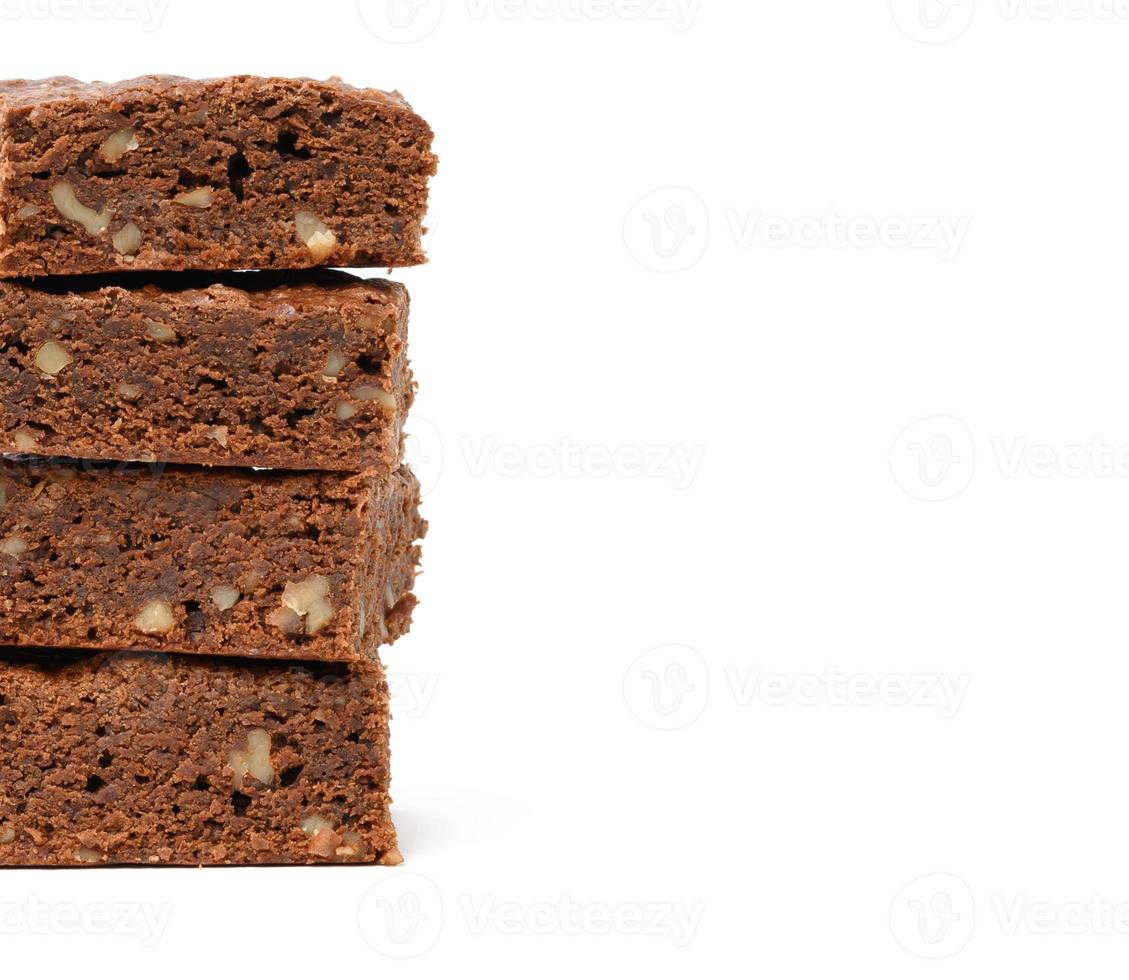 stack of baked chocolate brownie pieces with walnut isolated on white background, delicious dessert photo