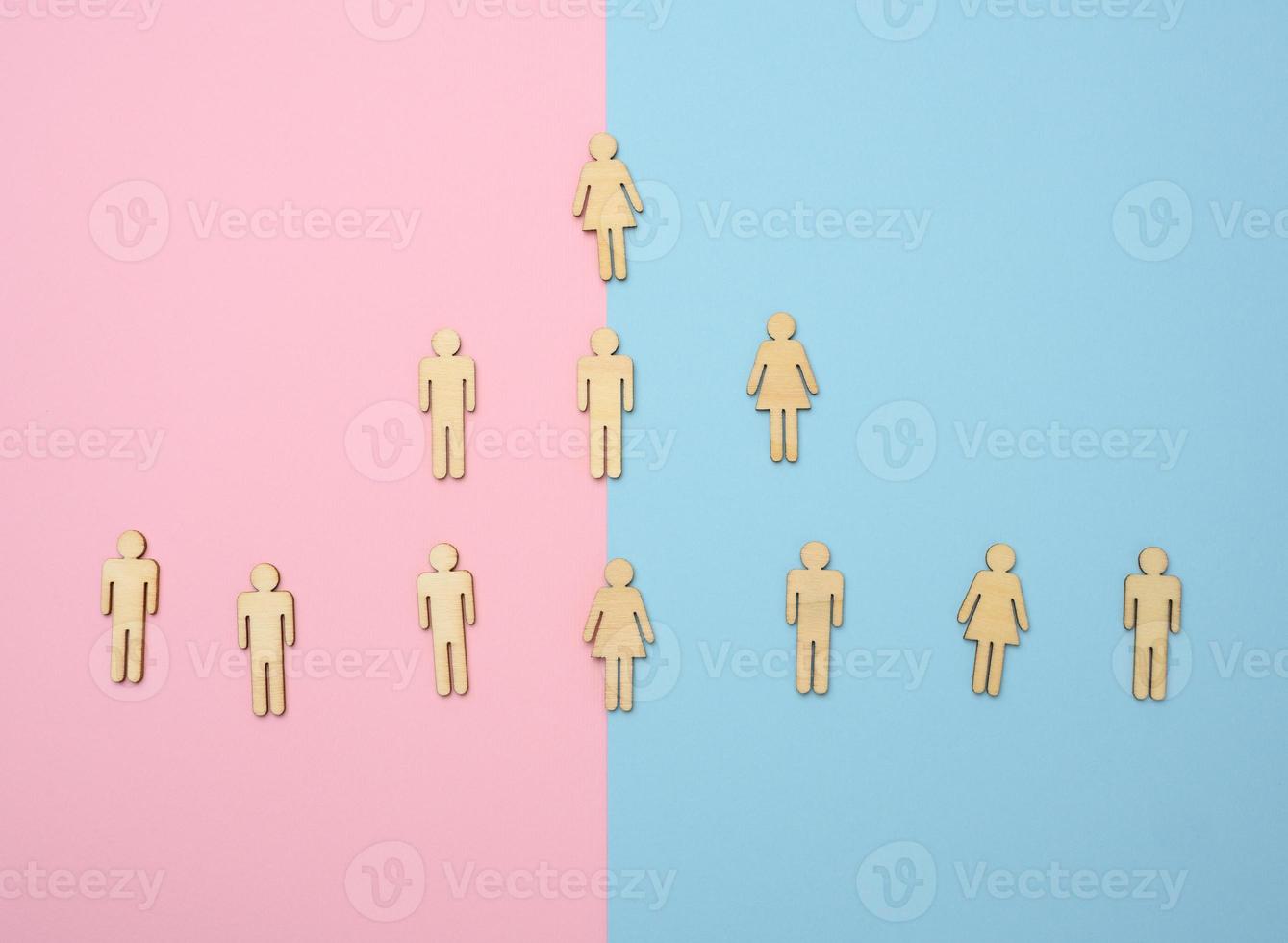 wooden figures on a blue pink background, hierarchical organizational structure of management, effective management model in the organization photo