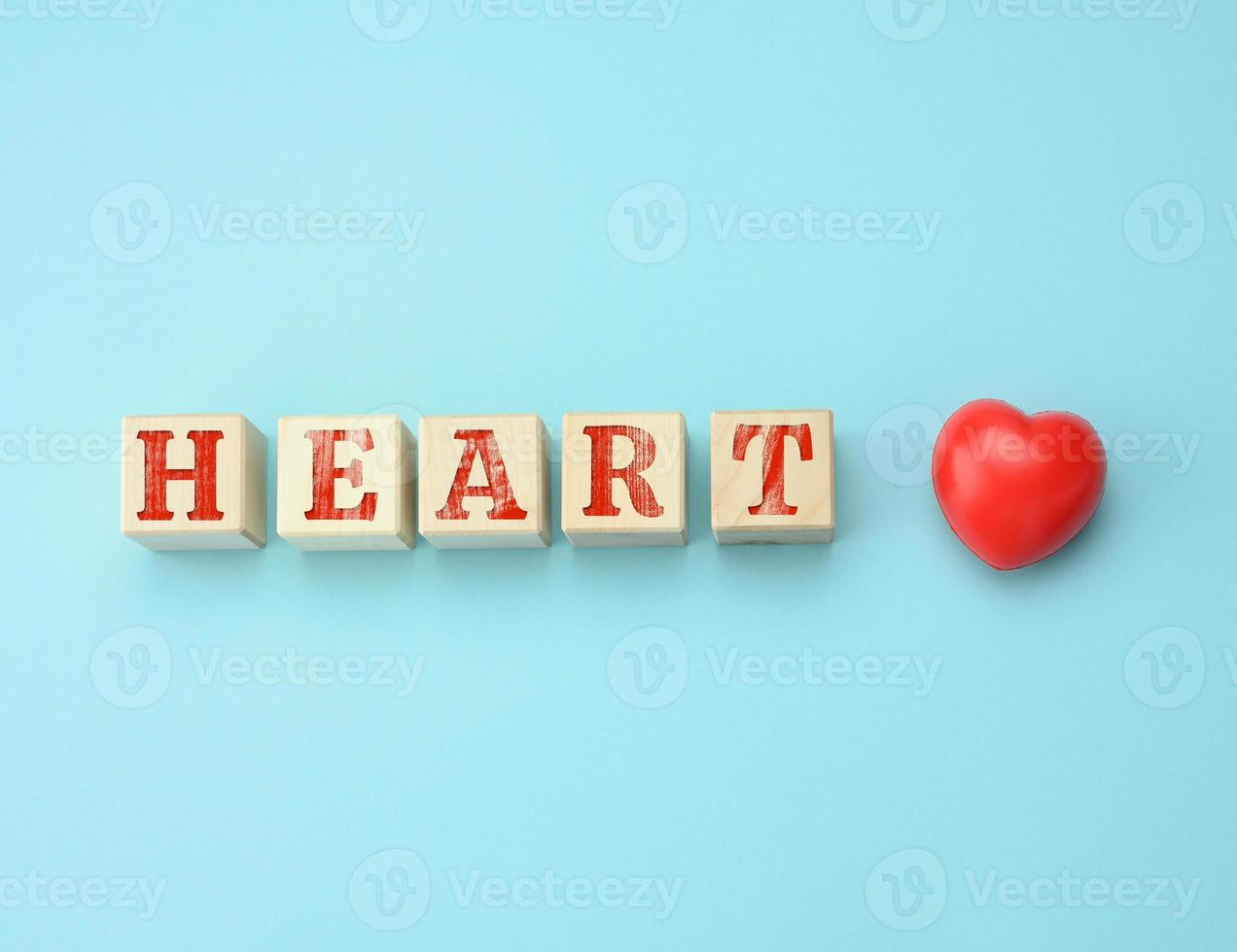 wooden blocks with the inscription Heart Day on a blue background. Concept for health care photo
