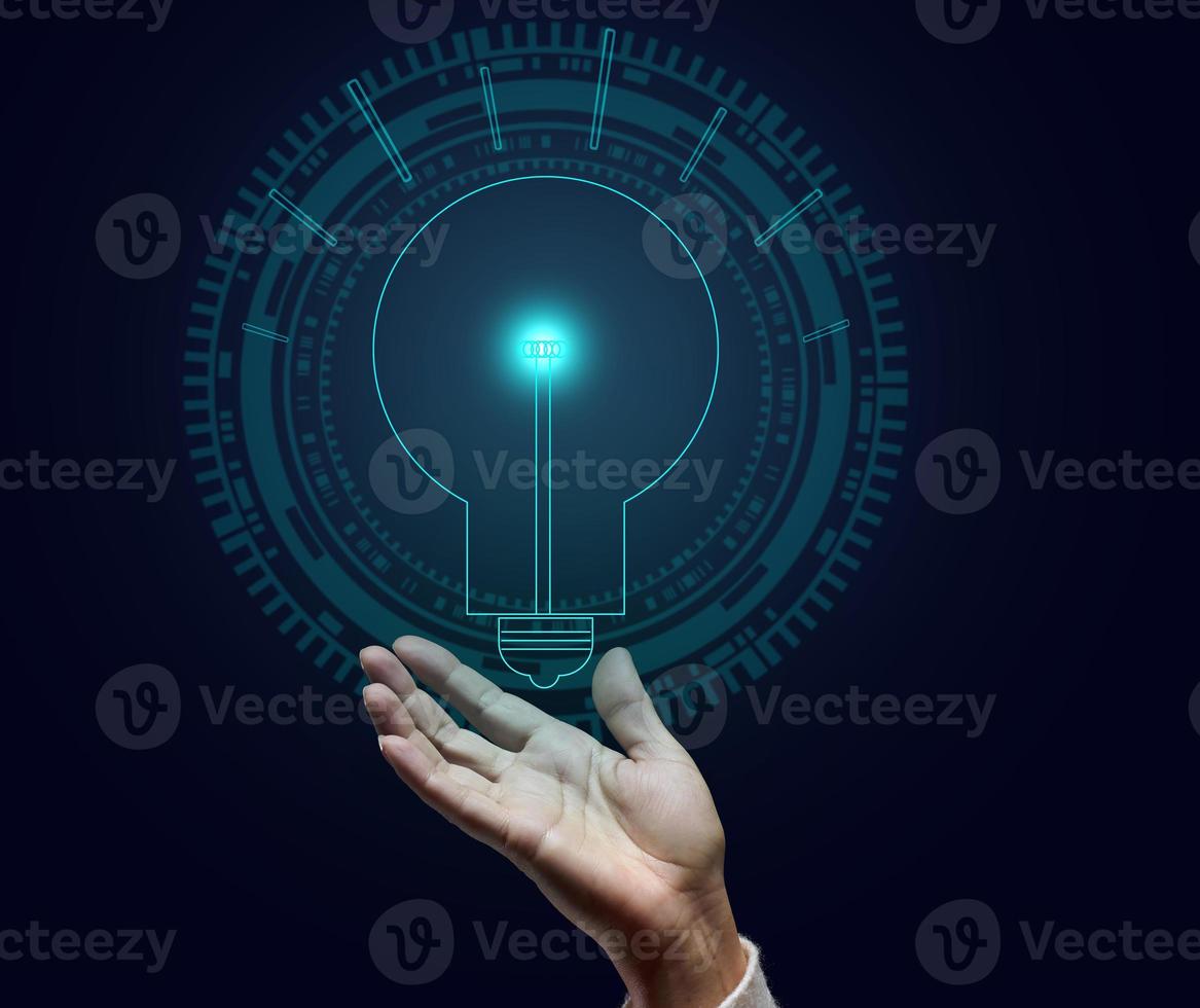 holographic lamp and female hand on a dark blue background. Concept of new ideas, brainstorming. Opening a profitable business photo